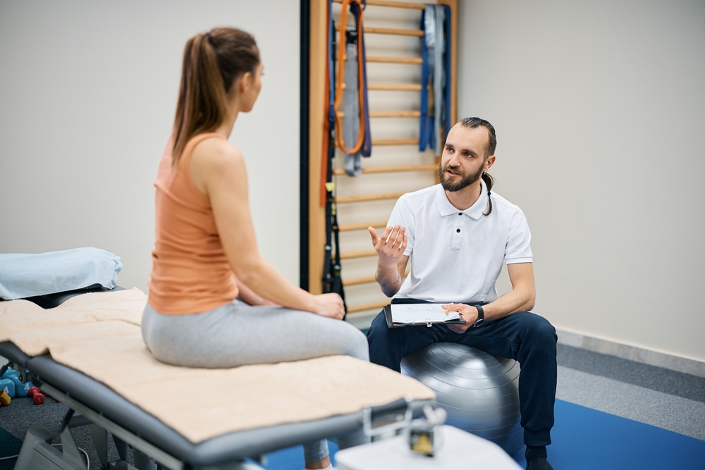 Physical therapist talking to patient