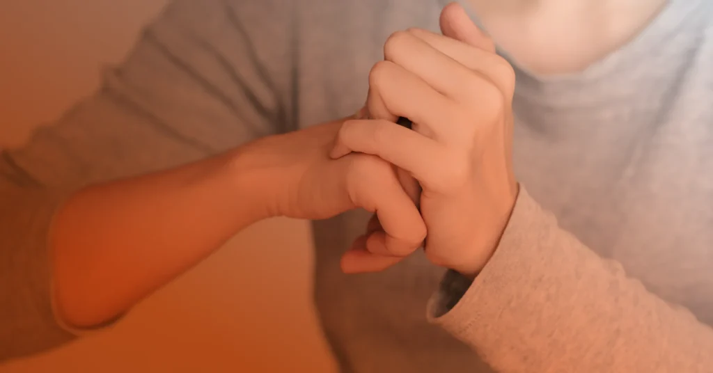 Close up shot of a person cracking their knuckles.