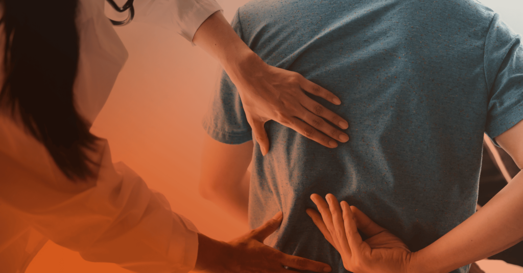 Close-up shot of a doctor examining a patient's back.