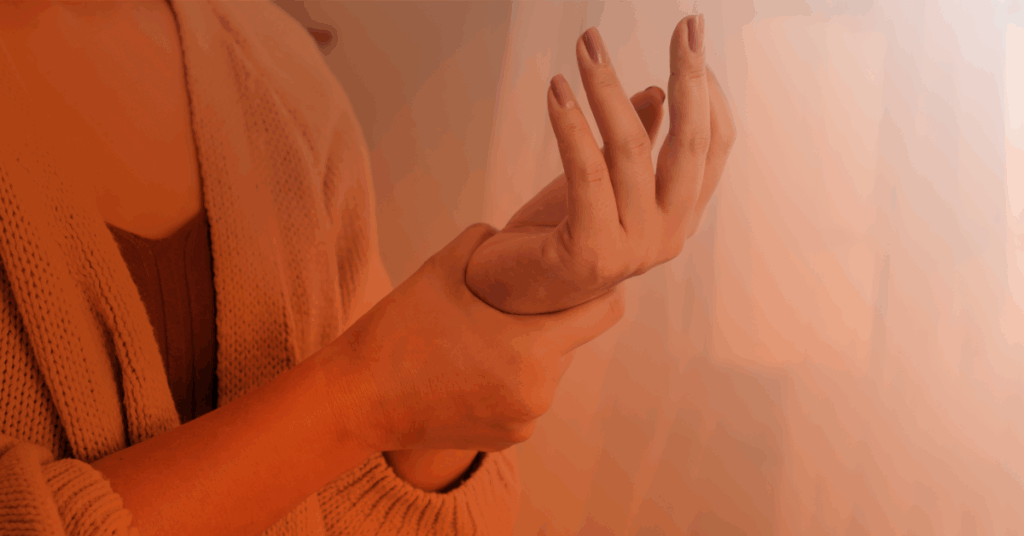 woman holding her wrist in pain