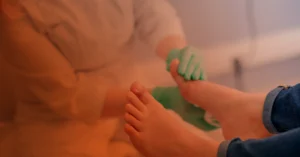 A doctor examines a patient's foot