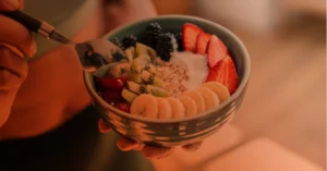 Close up image of a nutritious bowl of fruits, yogurt, and grains for injury recovery.