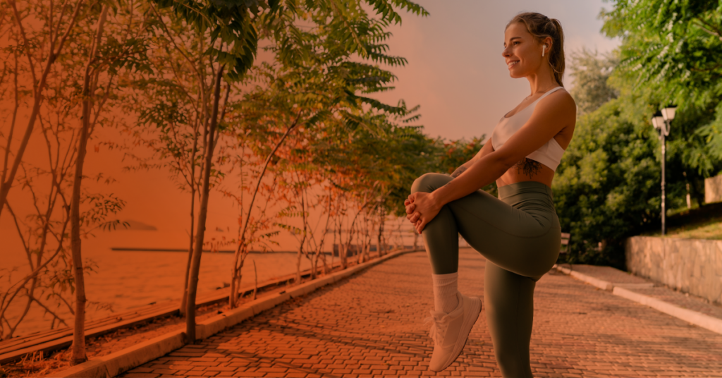 A woman stretching in a park.