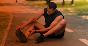 A man stretching his aching foot.