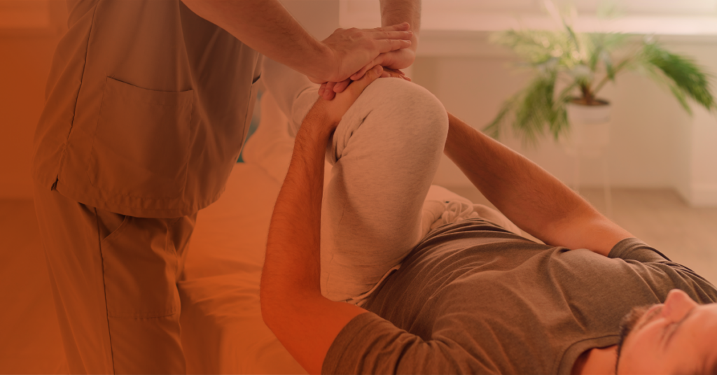 A physical therapist helps a patient recover.