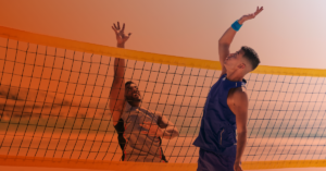Two friends playing beach volleyball.