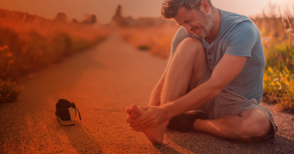 man holding foot in pain