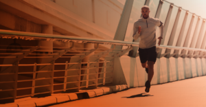 man running across a bridge